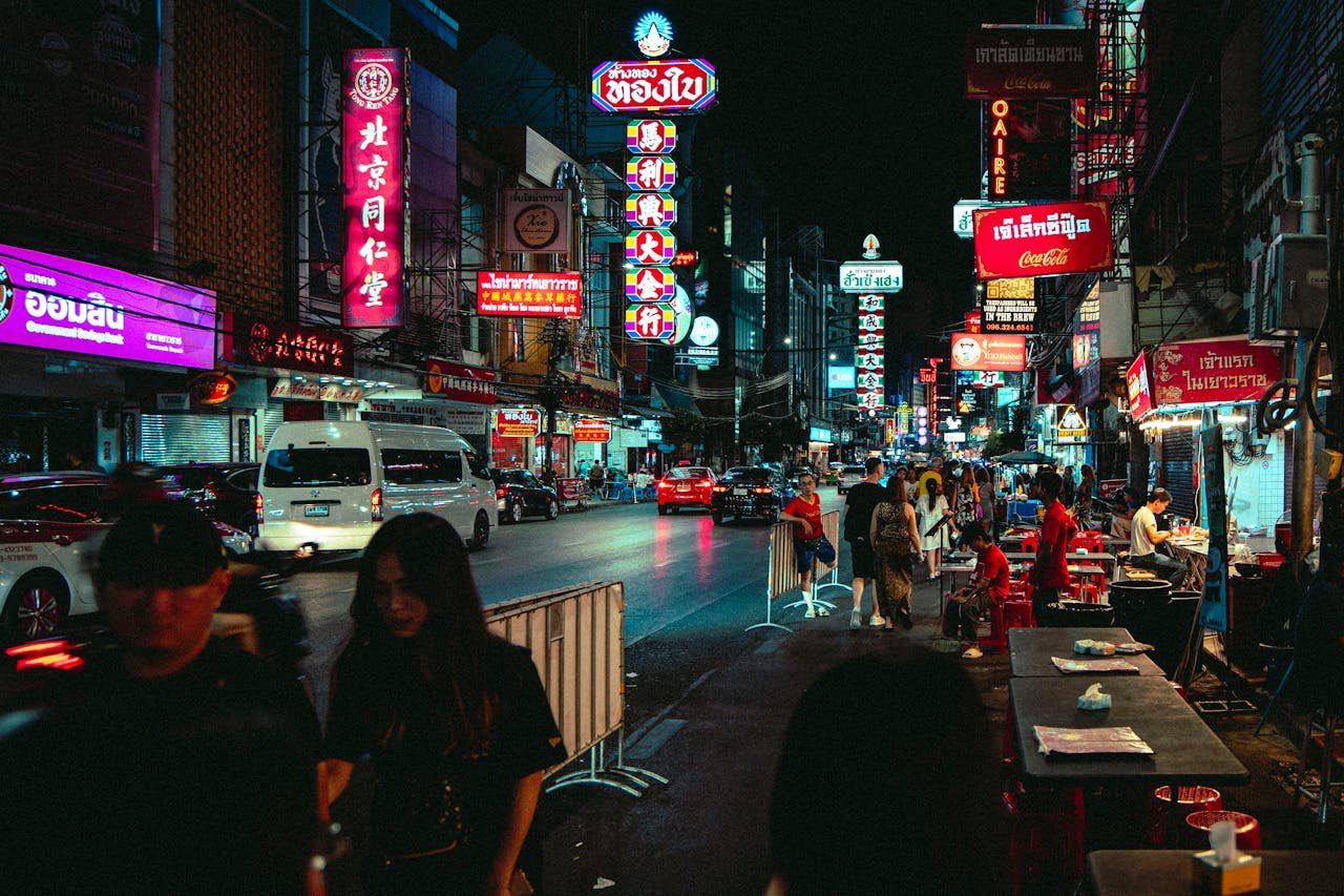 Bangkok's Chinatown (Yaowarat) at night with neon signs and bustling street food stalls