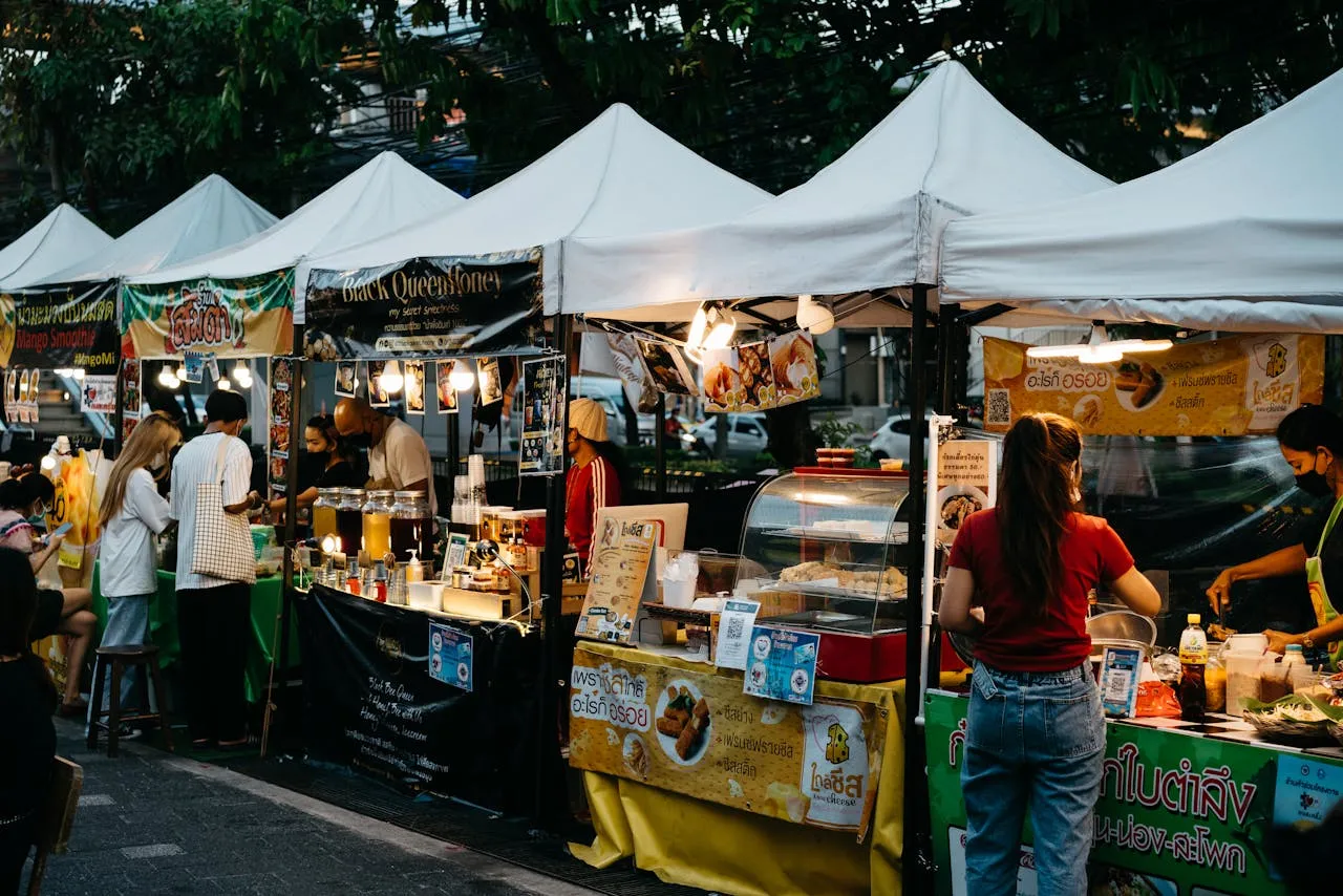 Vibrant Bangkok night market with tourists enjoying authentic Thai street food tours