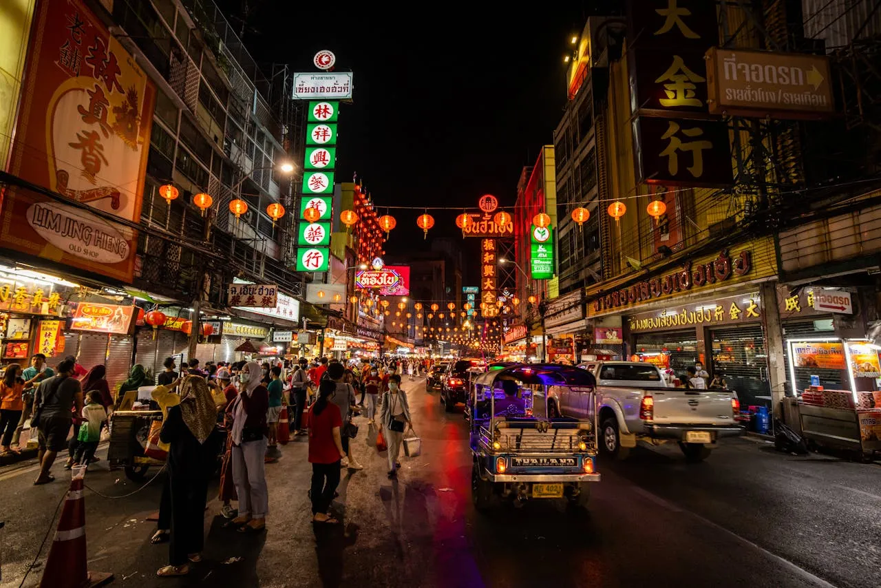 Tourists enjoy Bangkok food tour by tuk-tuk at night