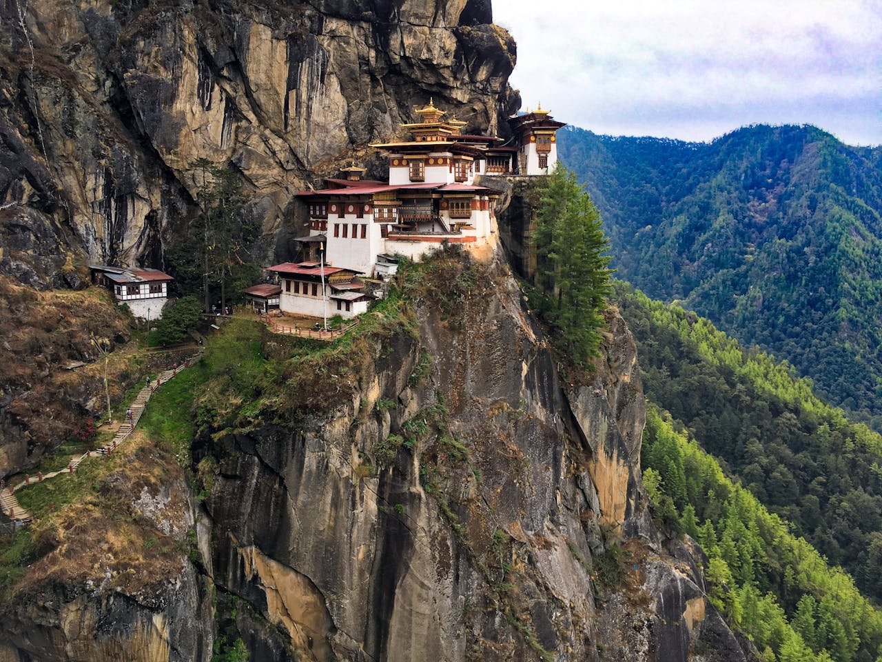 White, Black, and Brown House Beside Moutantiasn Bhutan