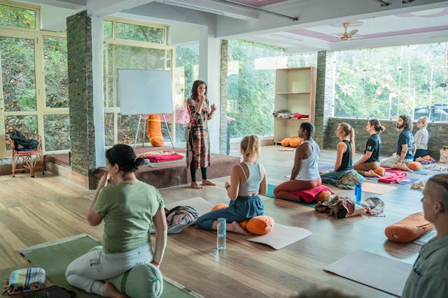 Women Sitting on Floor in Yoga Class Rishikesh, UT, India