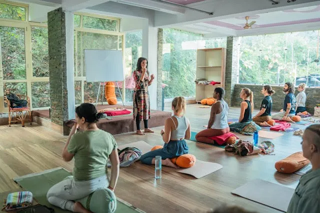 Women Sitting on Floor in Yoga Class Rishikesh, UT, India