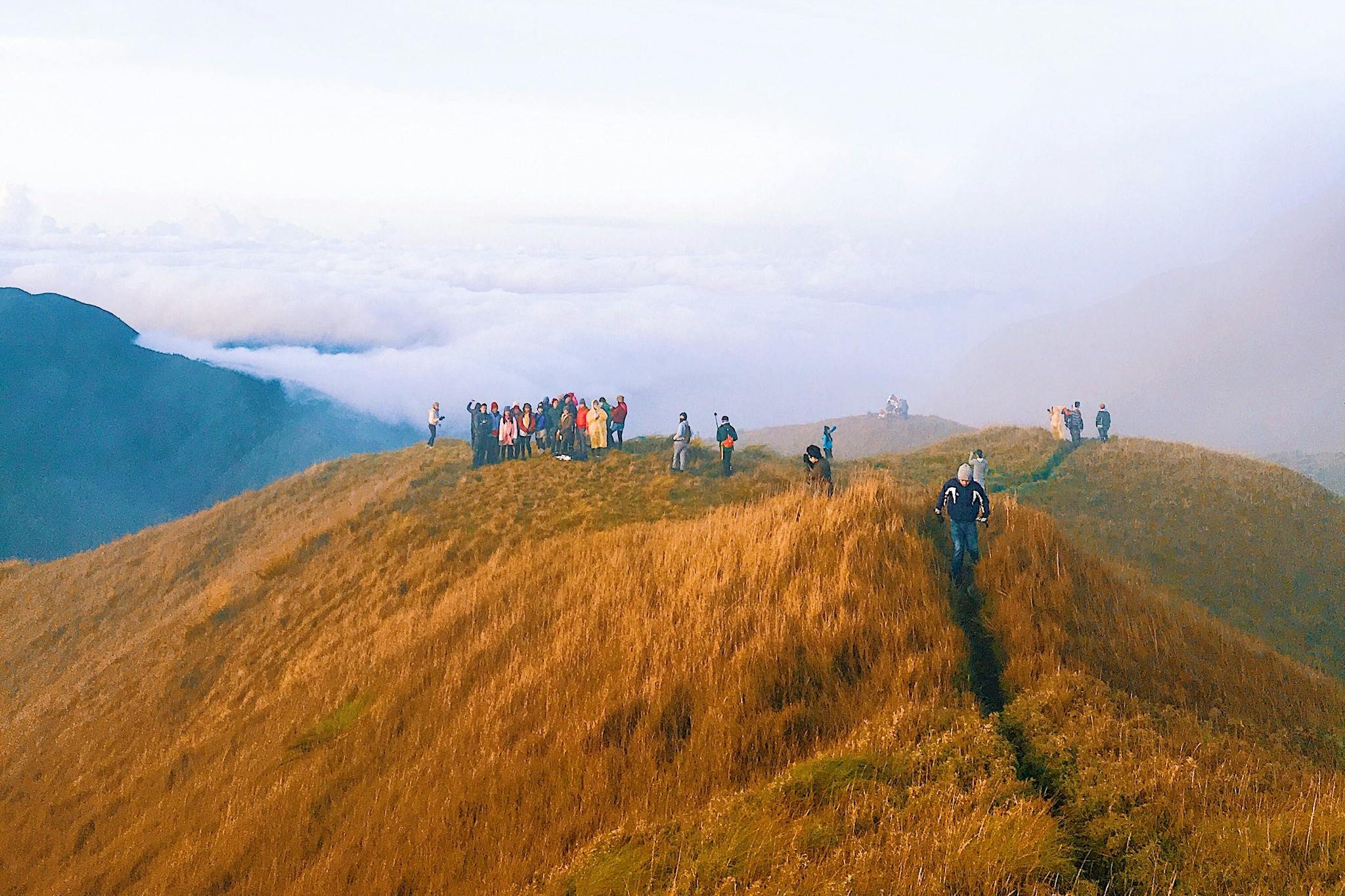 Explore the breathtaking vistas of Cagayan Valley with a group of hikers on a scenic mountain ridge.