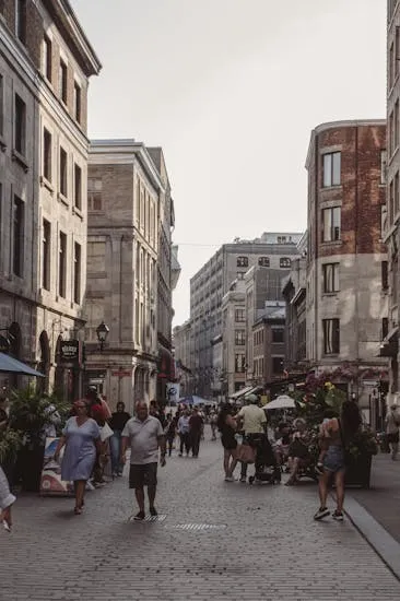Lively scene of a busy street with people enjoying the historic architecture.