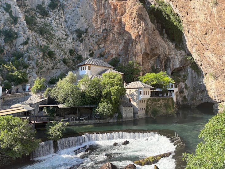 Dramatic view of the Dervish House at Buna Spring in Blagaj, blending nature and architecture.