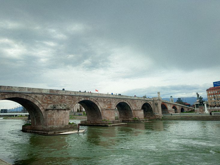 View of the iconic Stone Bridge across the Vardar River in Skopje, capturing its historic architecture.